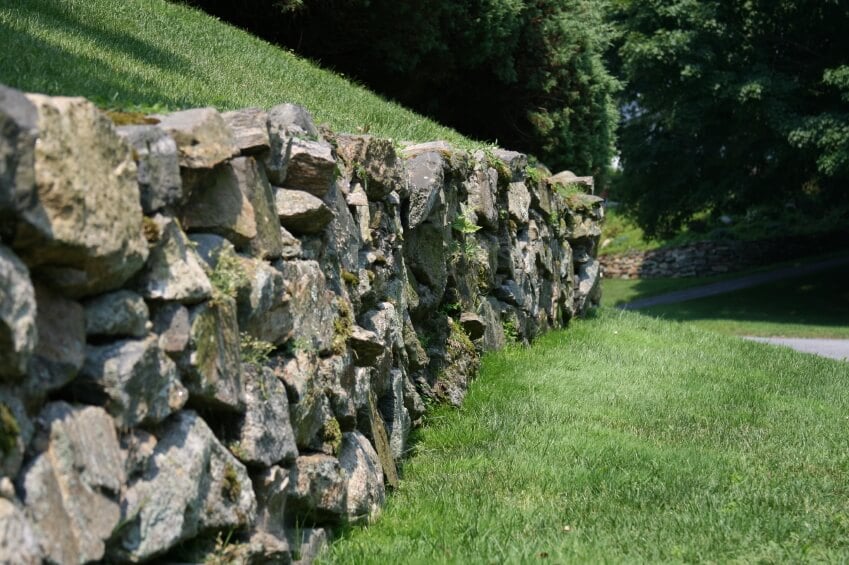 一条铺好的小路边有一堵更乡村、质朴的挡土墙，在大山坡上形成了一个露台。古老的石头上长着青苔，表明这堵墙年代久远。