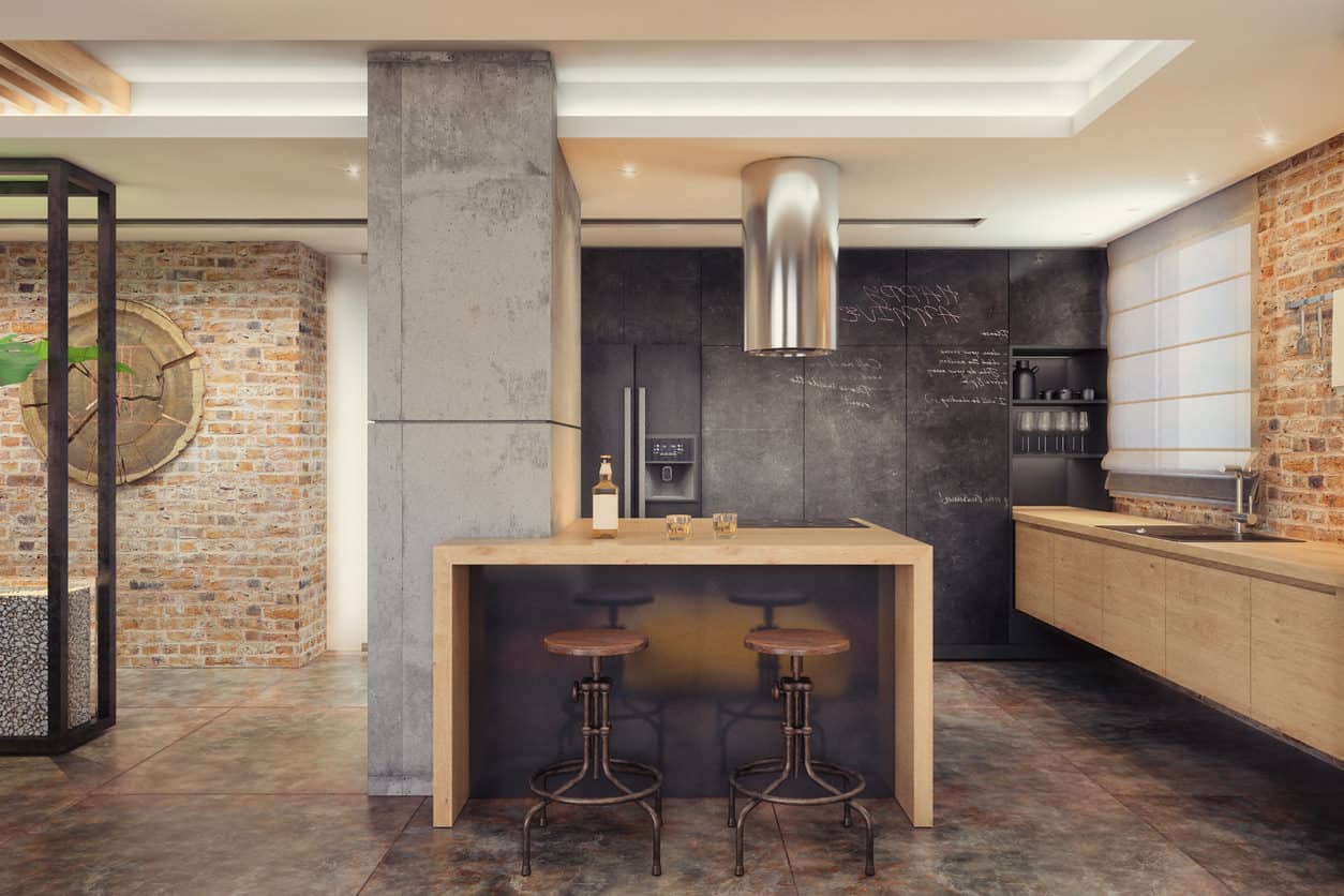 小型现代时髦的工业风格厨房，浮动橱柜，粉笔墙，混凝土支撑柱和暴露的砖墙。
